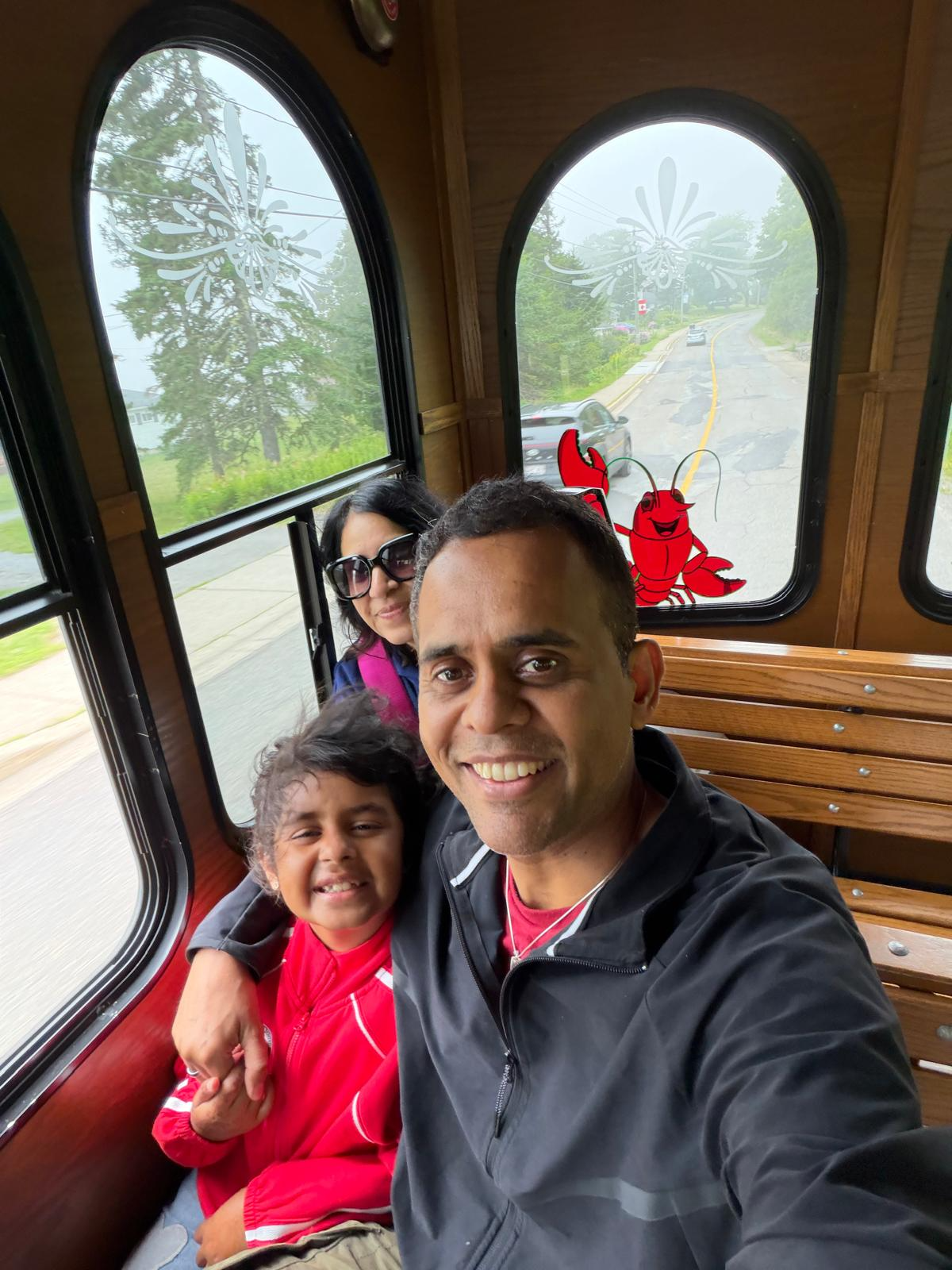 Kartik enjoying a tram ride with his family